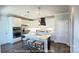 Modern kitchen with white cabinets, stainless steel appliances, a center island with barstool seating, and pendant lighting at 19732-A School St, Cornelius, NC 28031