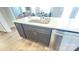 A kitchen island featuring a stainless steel sink, light countertops and dark wood cabinets at 19732-A School St, Cornelius, NC 28031