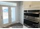 A view of a modern kitchen with stainless steel appliances and a view to the backyard at 19732-A School St, Cornelius, NC 28031