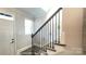 Close-up of a staircase with dark wood railings, white risers, and modern design, adjacent to a white door at 19732-A School St, Cornelius, NC 28031