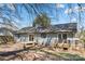 Backyard with patio and small deck, siding and dark roof, with treed perimeter at 205 King David Ln, Gastonia, NC 28056