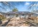 Backyard view featuring a deck and patio, mature trees, and fencing at 205 King David Ln, Gastonia, NC 28056