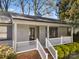 Inviting front porch with white railings and brick accents, offering a cozy entrance to this charming home at 205 King David Ln, Gastonia, NC 28056