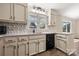 Well-lit kitchen featuring custom backsplash, granite countertops, black appliances, and wood-look flooring at 205 King David Ln, Gastonia, NC 28056