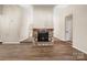 Spacious living room featuring a stone fireplace, wood-look flooring, and an open layout for comfortable living at 205 King David Ln, Gastonia, NC 28056