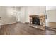 Open living room featuring a stone fireplace and modern lighting at 205 King David Ln, Gastonia, NC 28056