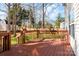 A wooden deck overlooks a landscaped backyard bordered by a fence and trees, providing a private outdoor space at 2426 Tory Oak Pl, Matthews, NC 28105