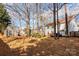 Spacious backyard with a shed, wooden fence, and mature trees offering ample room for outdoor activities and relaxation at 2426 Tory Oak Pl, Matthews, NC 28105