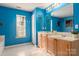 Bright blue bathroom featuring a double vanity and large mirror at 2426 Tory Oak Pl, Matthews, NC 28105