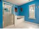 Bright blue bathroom featuring a shower and soaking tub at 2426 Tory Oak Pl, Matthews, NC 28105