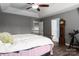Spacious bedroom with a tray ceiling, ceiling fan, and hardwood floors at 2426 Tory Oak Pl, Matthews, NC 28105
