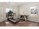 Bright bonus room with hardwood floors, featuring an air hockey table and treadmill at 2426 Tory Oak Pl, Matthews, NC 28105