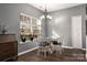 Bright dining area with natural light, a table, and hardwood floors at 2426 Tory Oak Pl, Matthews, NC 28105