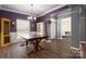 A traditional dining room features hardwood floors and a farmhouse style dining table at 2426 Tory Oak Pl, Matthews, NC 28105