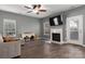 Inviting living room features hardwood floors, a ceiling fan, and a fireplace at 2426 Tory Oak Pl, Matthews, NC 28105