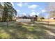 Spacious fenced backyard featuring lush greenery, an above-ground pool, and an inviting outdoor space at 2540 Deal Rd, Mooresville, NC 28115