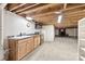 Spacious basement featuring a kitchen, sink, cabinets, and exposed wood beams at 2540 Deal Rd, Mooresville, NC 28115