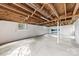 Unfinished basement featuring concrete flooring, exposed ceiling, and natural light from the windows at 2540 Deal Rd, Mooresville, NC 28115