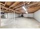 Unfinished basement with concrete floor and exposed wood ceiling, ready to be customized at 2540 Deal Rd, Mooresville, NC 28115