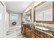 Bathroom featuring a black marble countertop, framed mirrors, and patterned floors at 2540 Deal Rd, Mooresville, NC 28115