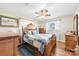 Bedroom features wood floors, a ceiling fan, and multiple windows at 2540 Deal Rd, Mooresville, NC 28115