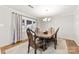 Elegant dining room with hardwood floors, a classic chandelier, and large windows offering natural light at 2540 Deal Rd, Mooresville, NC 28115