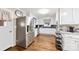 Well-lit kitchen featuring white cabinets, granite countertops, stainless steel appliances, and hardwood floors at 2540 Deal Rd, Mooresville, NC 28115