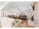 Bright and spacious living room featuring hardwood floors, a brick fireplace, and large windows for natural light at 2540 Deal Rd, Mooresville, NC 28115