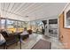 Relax in this enclosed sunroom with comfortable seating and views of the serene backyard at 2540 Deal Rd, Mooresville, NC 28115