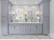 Dual sink bathroom vanity with marble counters, marble backsplash, and gold hardware at 300 Mammoth Oaks Dr, Charlotte, NC 28270