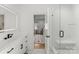 Elegant bathroom featuring modern fixtures, a glass-enclosed shower, and a seamless transition to the adjacent bedroom at 300 Mammoth Oaks Dr, Charlotte, NC 28270