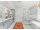 The bathroom features a walk-in glass shower, soaking tub, and double sink vanity with marble countertops at 300 Mammoth Oaks Dr, Charlotte, NC 28270
