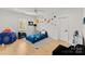 Vibrant bedroom showcases a whimsical space theme with unique decor, toys, and a cozy bed at 300 Mammoth Oaks Dr, Charlotte, NC 28270