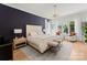 This main bedroom showcases a decorative light fixture, sleek decor, and a view of the outdoors at 300 Mammoth Oaks Dr, Charlotte, NC 28270
