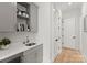 Butler's pantry features gray cabinets with gold hardware, open shelves and sink with faucet at 300 Mammoth Oaks Dr, Charlotte, NC 28270