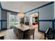 Elegant dining room featuring a modern chandelier, large window, and view to living space at 300 Mammoth Oaks Dr, Charlotte, NC 28270