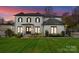 Charming white brick home featuring a manicured lawn, striking black shutters and a welcoming entranceway at 300 Mammoth Oaks Dr, Charlotte, NC 28270