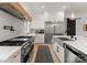 Modern kitchen with stainless steel appliances, large island, custom cabinets, and black accents at 300 Mammoth Oaks Dr, Charlotte, NC 28270