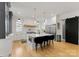Stunning white kitchen with a large island, stainless steel appliances, modern pendant lighting and barstool seating at 300 Mammoth Oaks Dr, Charlotte, NC 28270