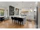Stylish kitchen featuring custom cabinetry, a large island with seating, pendant lights, and hardwood floors at 300 Mammoth Oaks Dr, Charlotte, NC 28270