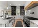 Contemporary kitchen with a stainless steel farmhouse sink, modern cabinetry, and professional grade appliances at 300 Mammoth Oaks Dr, Charlotte, NC 28270