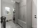Modern laundry room features patterned tile floors, gray cabinetry and stacked washer and dryer for space saving convenience at 300 Mammoth Oaks Dr, Charlotte, NC 28270