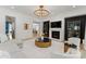 Open concept living room with fireplace, modern chandelier, and hardwood floors at 300 Mammoth Oaks Dr, Charlotte, NC 28270
