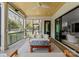 Stylish covered patio features wood ceiling, black railings, and comfortable seating with a view of the backyard at 300 Mammoth Oaks Dr, Charlotte, NC 28270