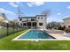 Stunning backyard oasis featuring a modern pool, hot tub, and lush landscaping, perfect for relaxation and recreation at 300 Mammoth Oaks Dr, Charlotte, NC 28270
