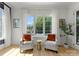 Relax in this sitting room overlooking the pool area with comfortable chairs and an abundance of natural light at 300 Mammoth Oaks Dr, Charlotte, NC 28270