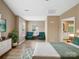 Bright bedroom with hardwood floors, sitting area, ensuite bathroom, and ample natural light at 3140 S Legacy Park Blvd, Fort Mill, SC 29707