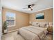 Neutral bedroom with a ceiling fan, natural light, and coordinating bedside tables at 3140 S Legacy Park Blvd, Fort Mill, SC 29707