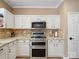 Close up of the kitchen with white cabinets, granite countertops, and stainless steel appliances at 3140 S Legacy Park Blvd, Fort Mill, SC 29707