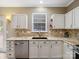 Close up of a section of the kitchen featuring white cabinets, granite countertops, and tile backsplash at 3140 S Legacy Park Blvd, Fort Mill, SC 29707
